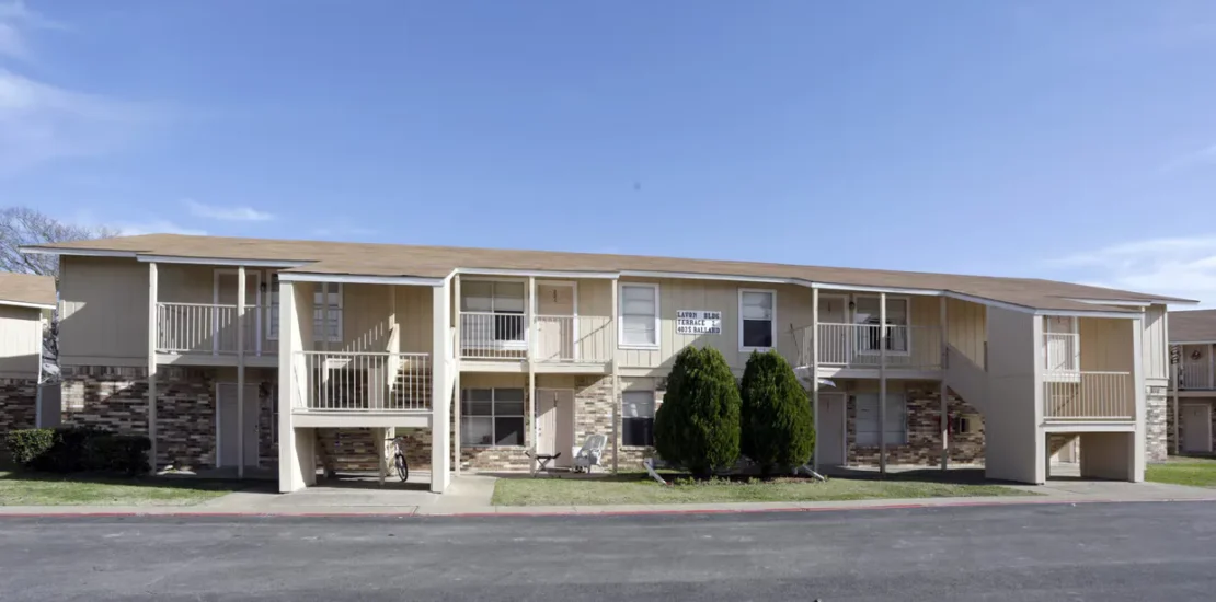 Two-story multifamily apartment complex with balconies and brick accents at Lavon Terrace in Wylie, Texas