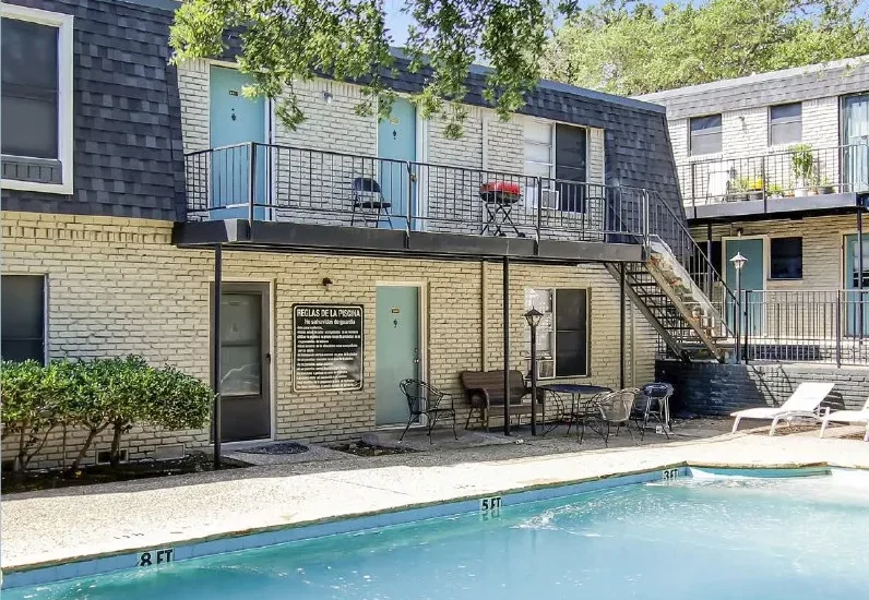 The Ridgemont apartment complex poolside view with two-story brick building in Fort Worth, Texas
